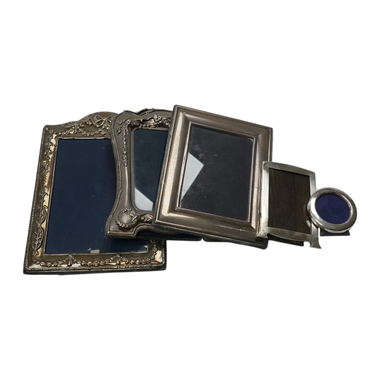 A small George V silver mounted photograph frame, 11.2cm, together with three larger modern silver mounted photograph fames and an 800 standard frame. Condition - poor to fair